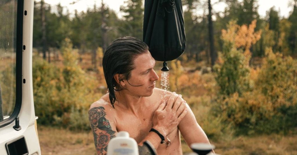 Man taking solar camp shower