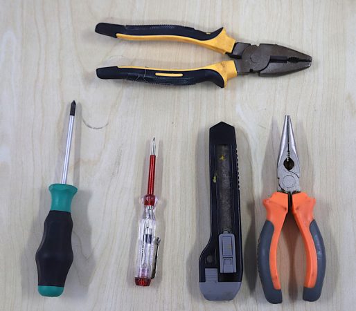 plier, wire cutter, screwdrivers, and multimeter tools on table