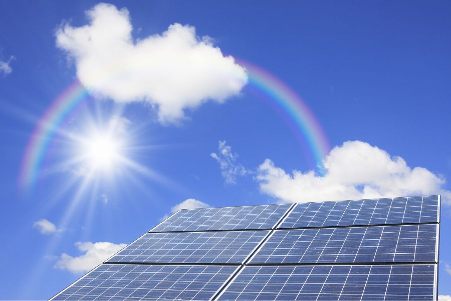 Solar panels with sunlight and rainbow