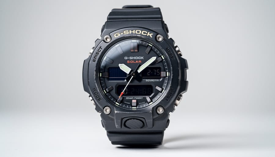 Close-up of G-Shock solar watch face showing solar panel cells beneath digital display
